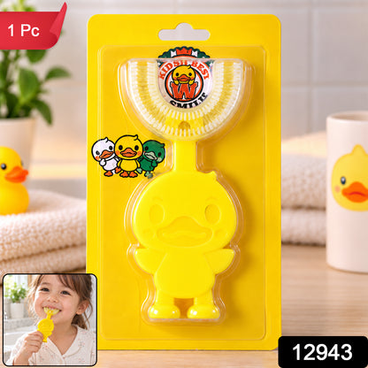 A yellow duck-shaped U-shaped toothbrush in packaging, with a small inset image of a child using it.