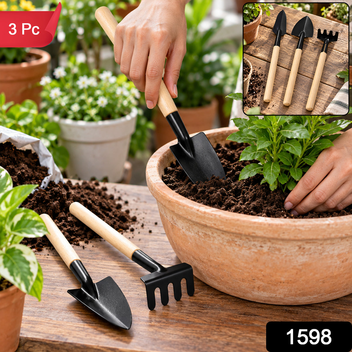 A person plants a flower with a small trowel, with two other tools and a bag of soil on a wooden surface.