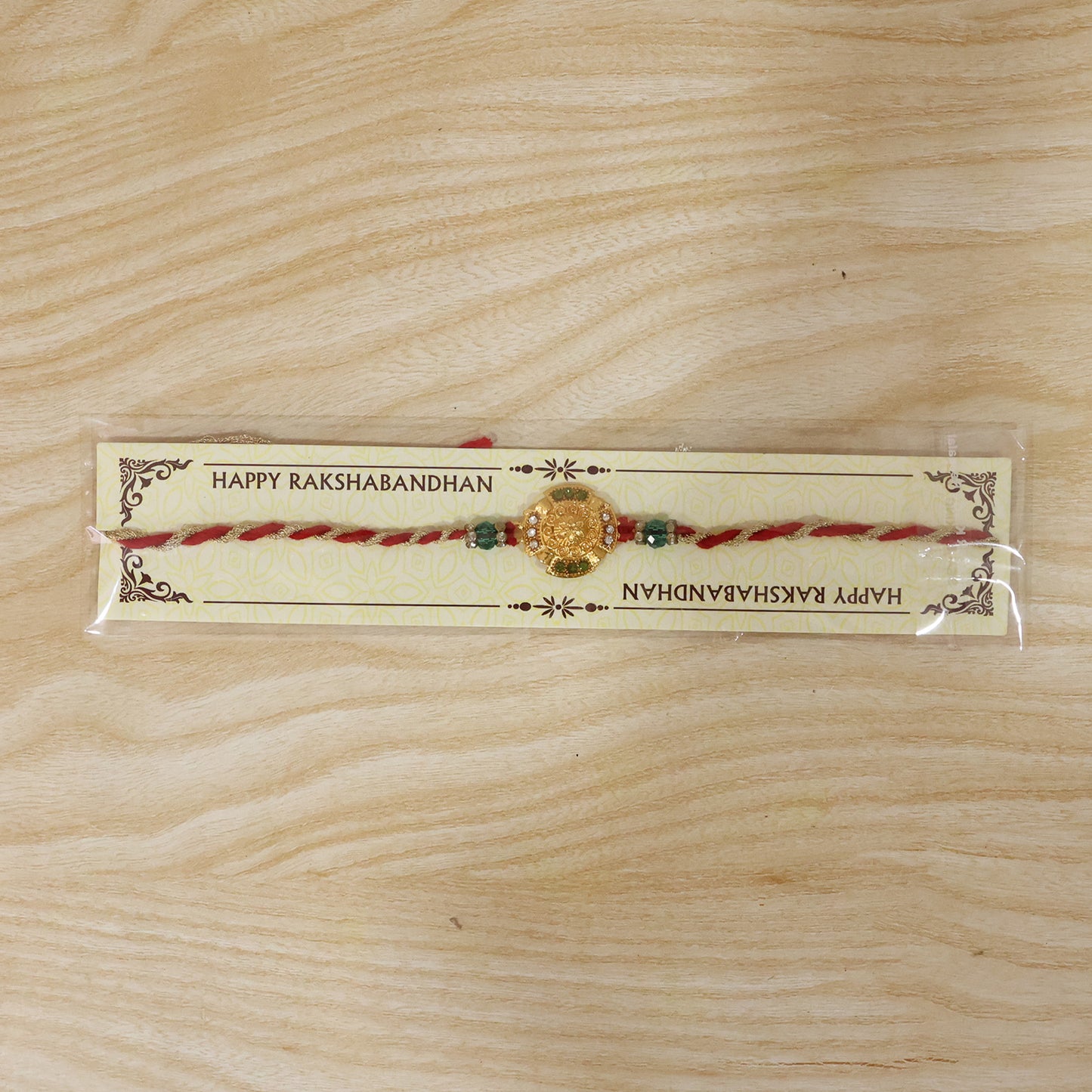 Traditional Gold Floral Coin Rakhi with Green Stone Beads