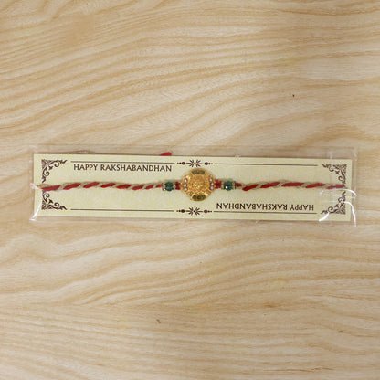 Traditional Gold Floral Coin Rakhi with Green Stone Beads