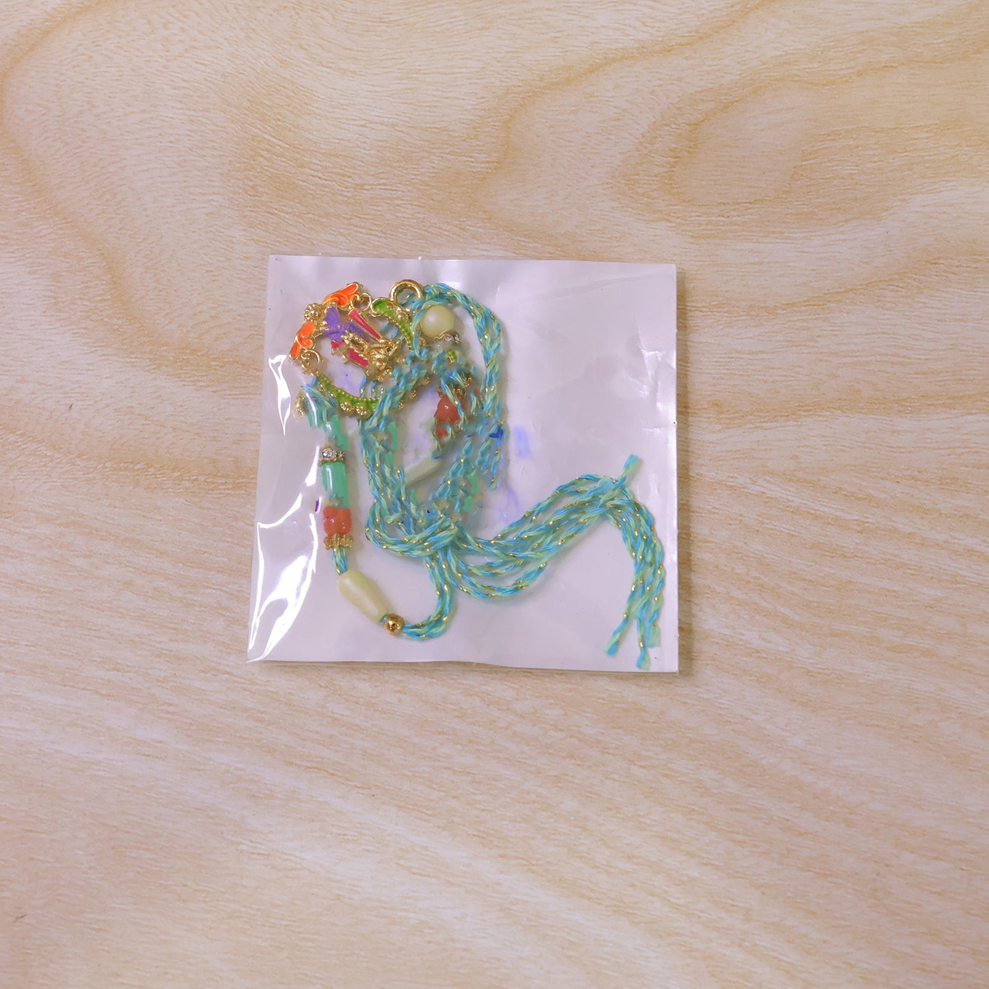 Lord Krishna Flute Arch Pendant Rakhi with Pastel Beads