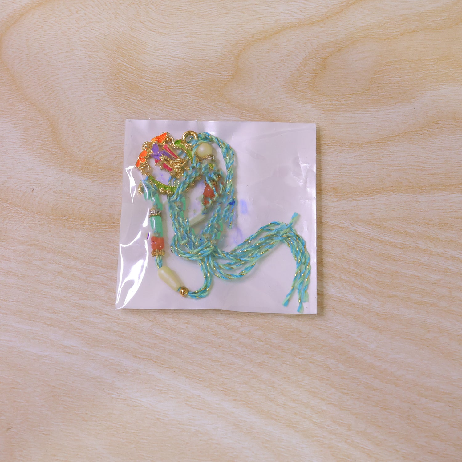Lord Krishna Flute Arch Pendant Rakhi with Pastel Beads