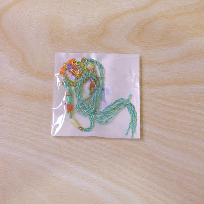 Lord Krishna Flute Arch Pendant Rakhi with Pastel Beads
