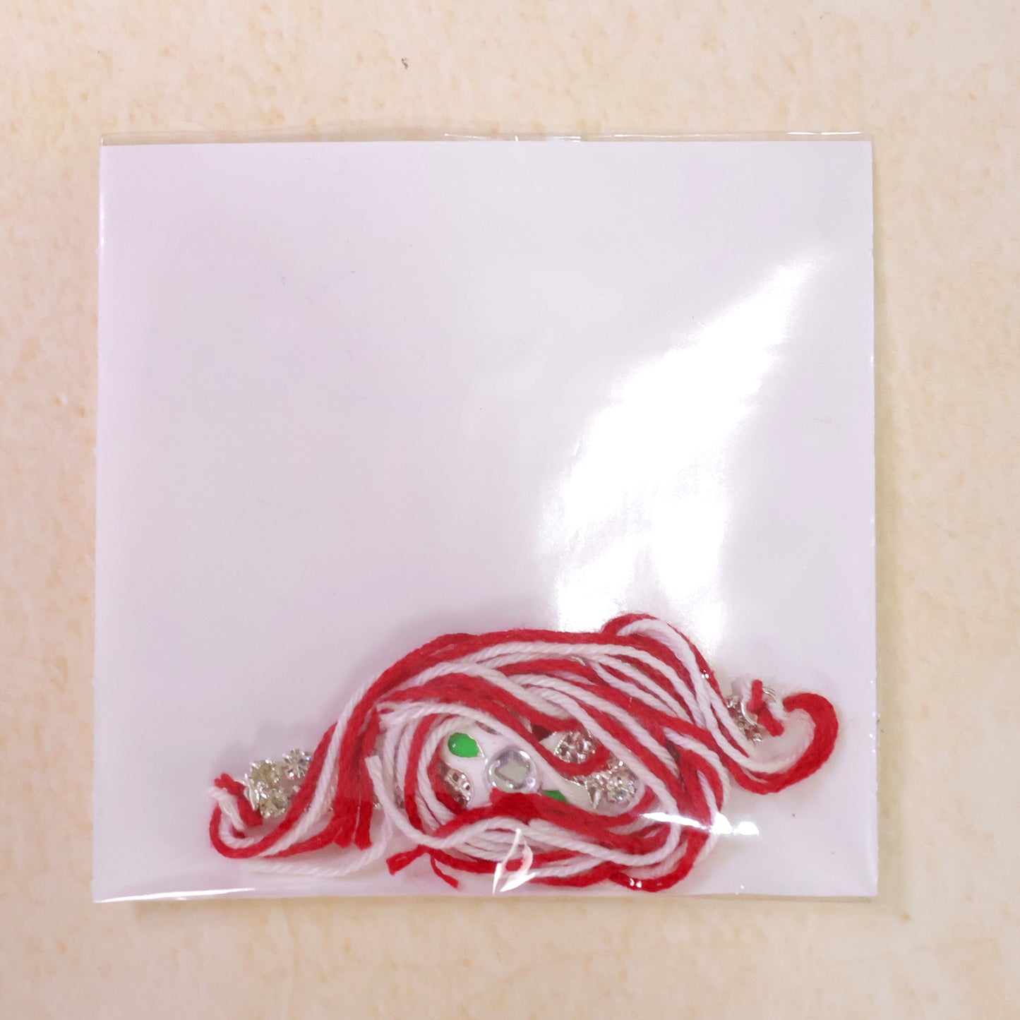 Festive Rakhi featuring Floral Circle Charm, pearl accents and chain look for Gifting