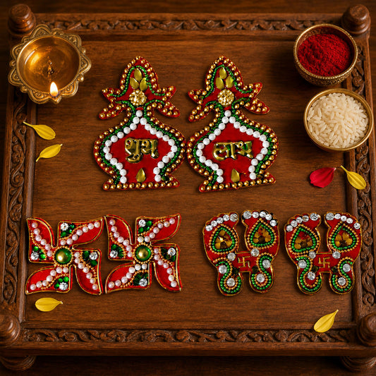 A set of red and gold Shubh Labh kalash, Swastik, and Laxmi Charan Paduka stickers on a wooden tray with diya and rice.