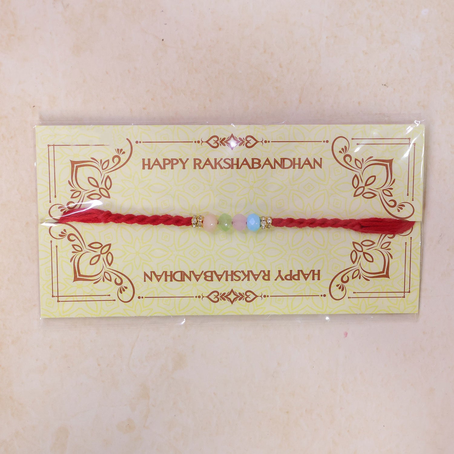 Red Twisted Cord Rakhi with Soft Pastel Multicolour Bead Accents