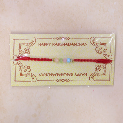 Red Twisted Cord Rakhi with Soft Pastel Multicolour Bead Accents
