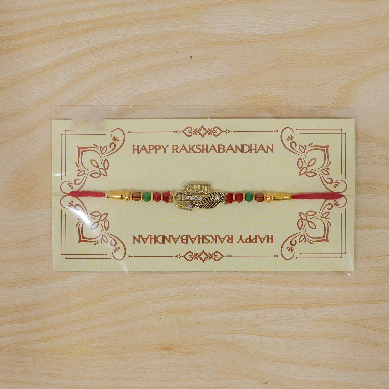 Veera Name Rakhi with Flute Leaf Style Centre, Stones and Red Green Beads