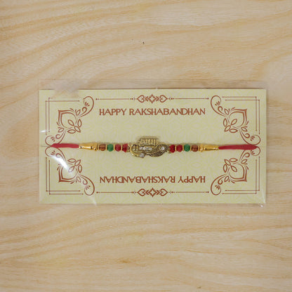 Veera Name Rakhi with Flute Leaf Style Centre, Stones and Red Green Beads