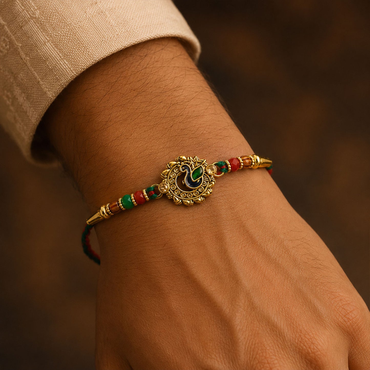 Green Peacock Enamel Rakhi with Golden Medallion, Multicolor Beads and Red Thread