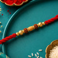 Red Thread Rakhi with a Row of Natural Rudraksha Bead Pendant