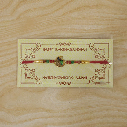 Green Peacock Paisley Rakhi with Golden Detail, Festive Beads and Red Thread