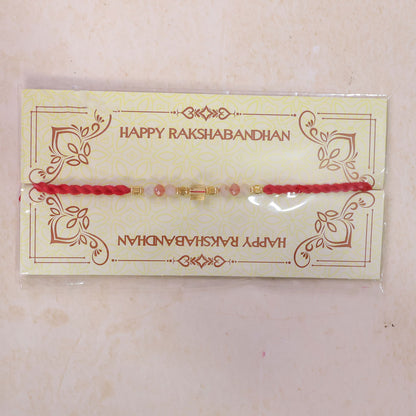 Red Thread Rakhi with Peach and Rose-Toned Crystal Bead Pendant