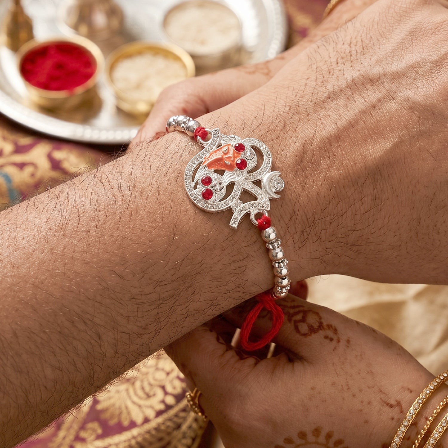 Silver Om Ganesh Rakhi with Red Stones and Metal Bead Chain