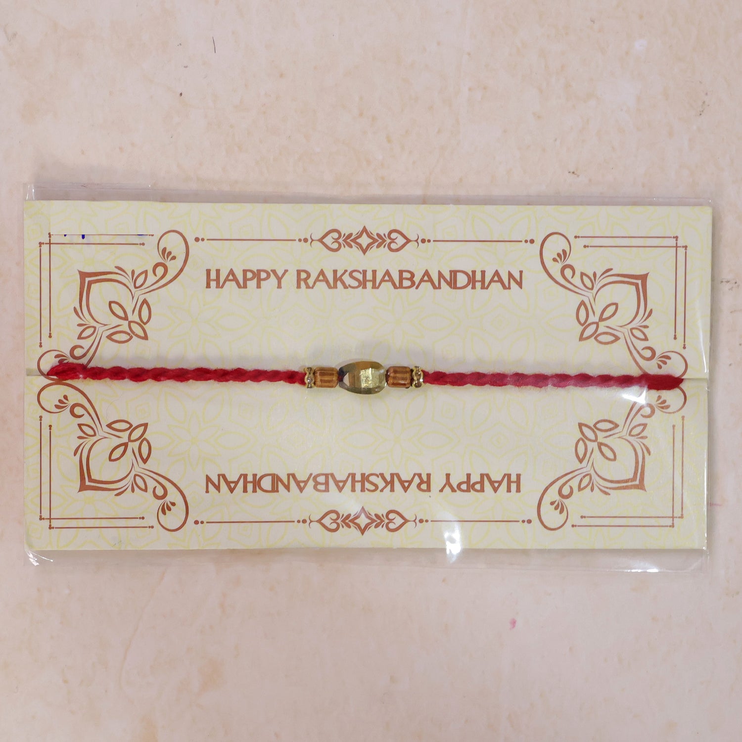 Red Thread Rakhi with Golden Oval Bead and Wooden Bead Accents