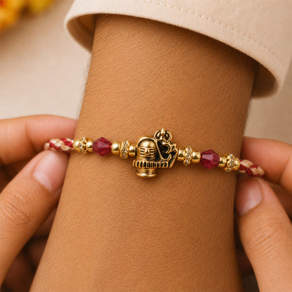 Sacred Deity Rakhi with Red-Beige Thread and Gold Pendant for Raksha Bandhan Gift