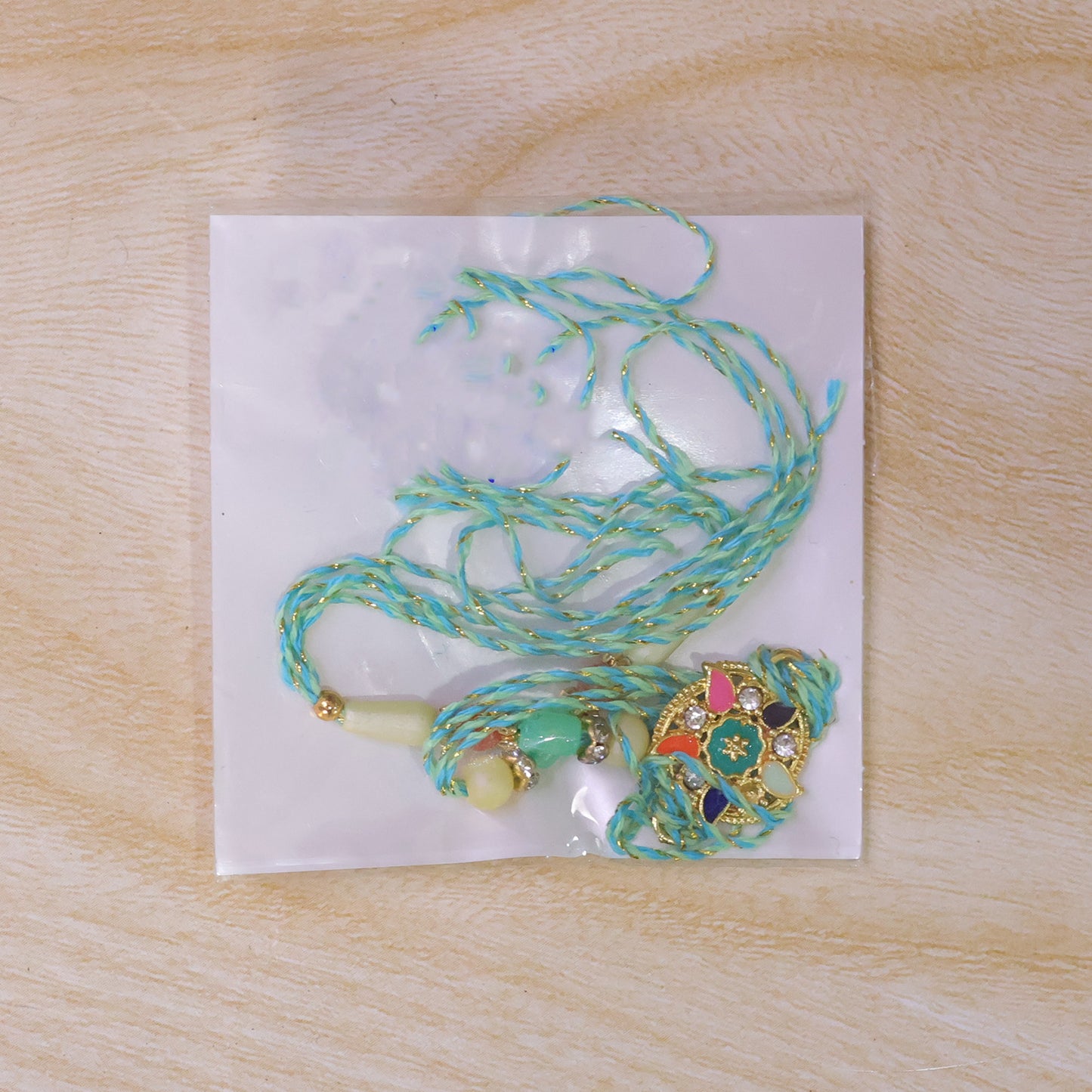 Multicolor Floral Kundan Pendant Rakhi with Pearl and Orange Beads
