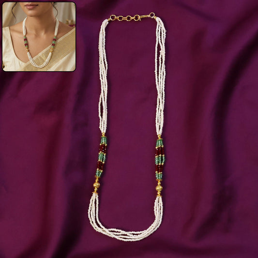 White beaded mala with red and green accents displayed on a white background