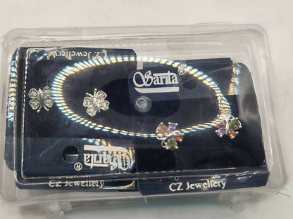 Packaged silver stud earrings set showcasing butterfly and floral designs with sparkling CZ stones