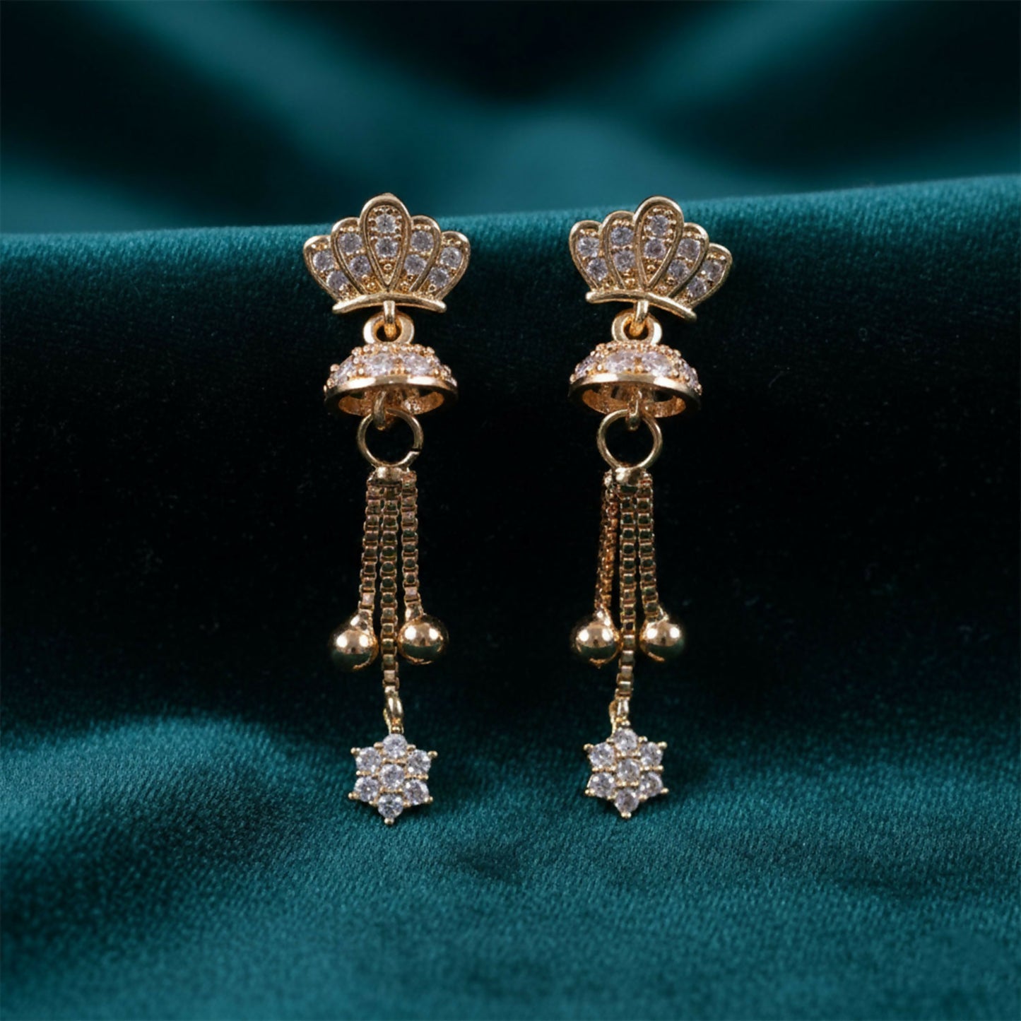 Crown design gold finish drop earrings with crystal tassel detail showcased on white background