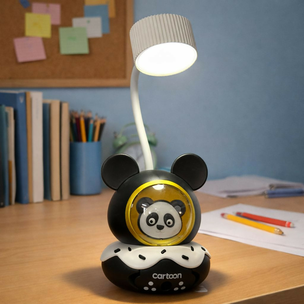 A panda-themed lamp sits on a wooden desk with school supplies, books, and a cork board in the background.