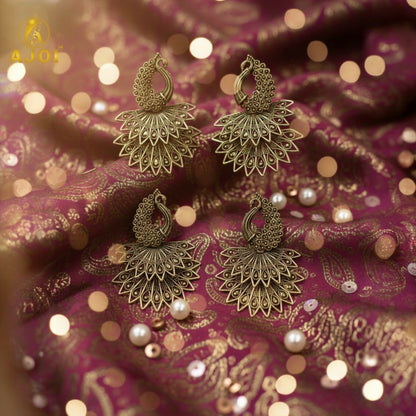 Side profile of peacock motif antique gold earrings