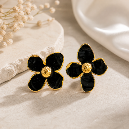 Side angle of black floral enamel stud earrings