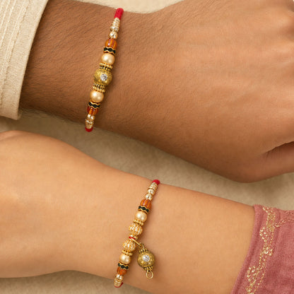 Golden Orb Couple Rakhi Set with Amber Beads and Hanging Charm for Bhaiya Bhabhi
