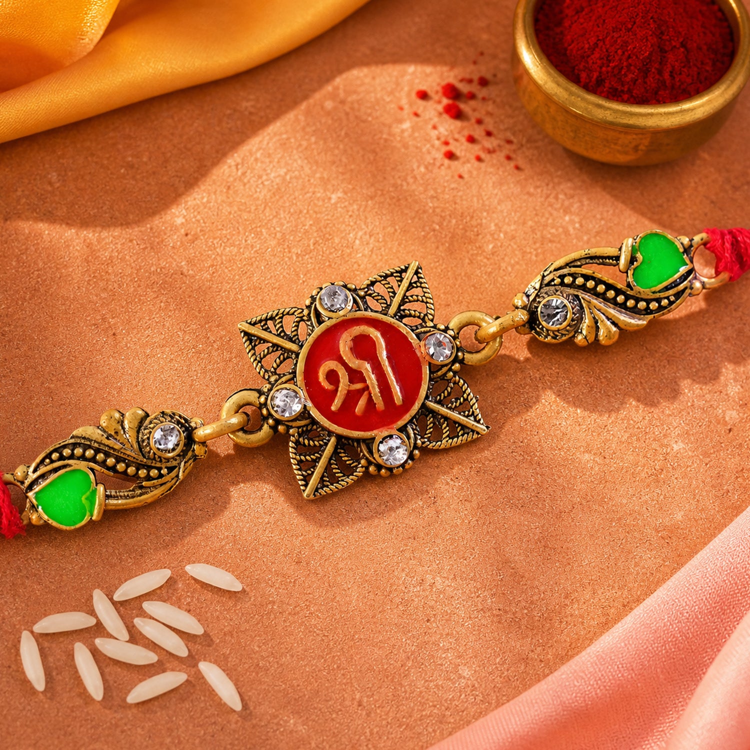 Antique Gold-Toned Shree Rakhi with Crystal Accents, Green Enamel & Designer Red Thread