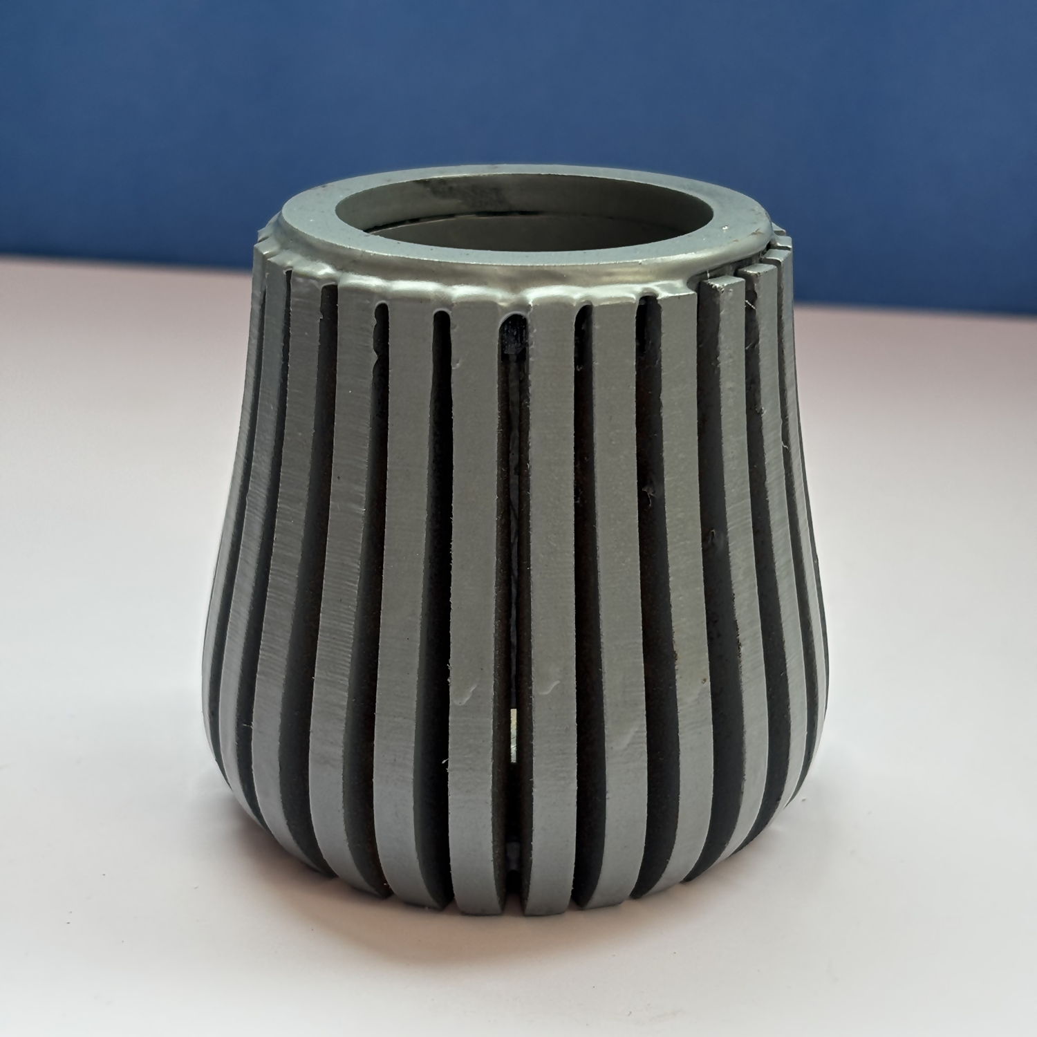 Contemporary grey wooden pen holder on a modern study table.
