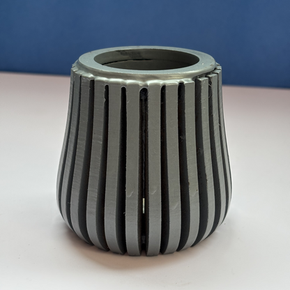 Contemporary grey wooden pen holder on a modern study table.