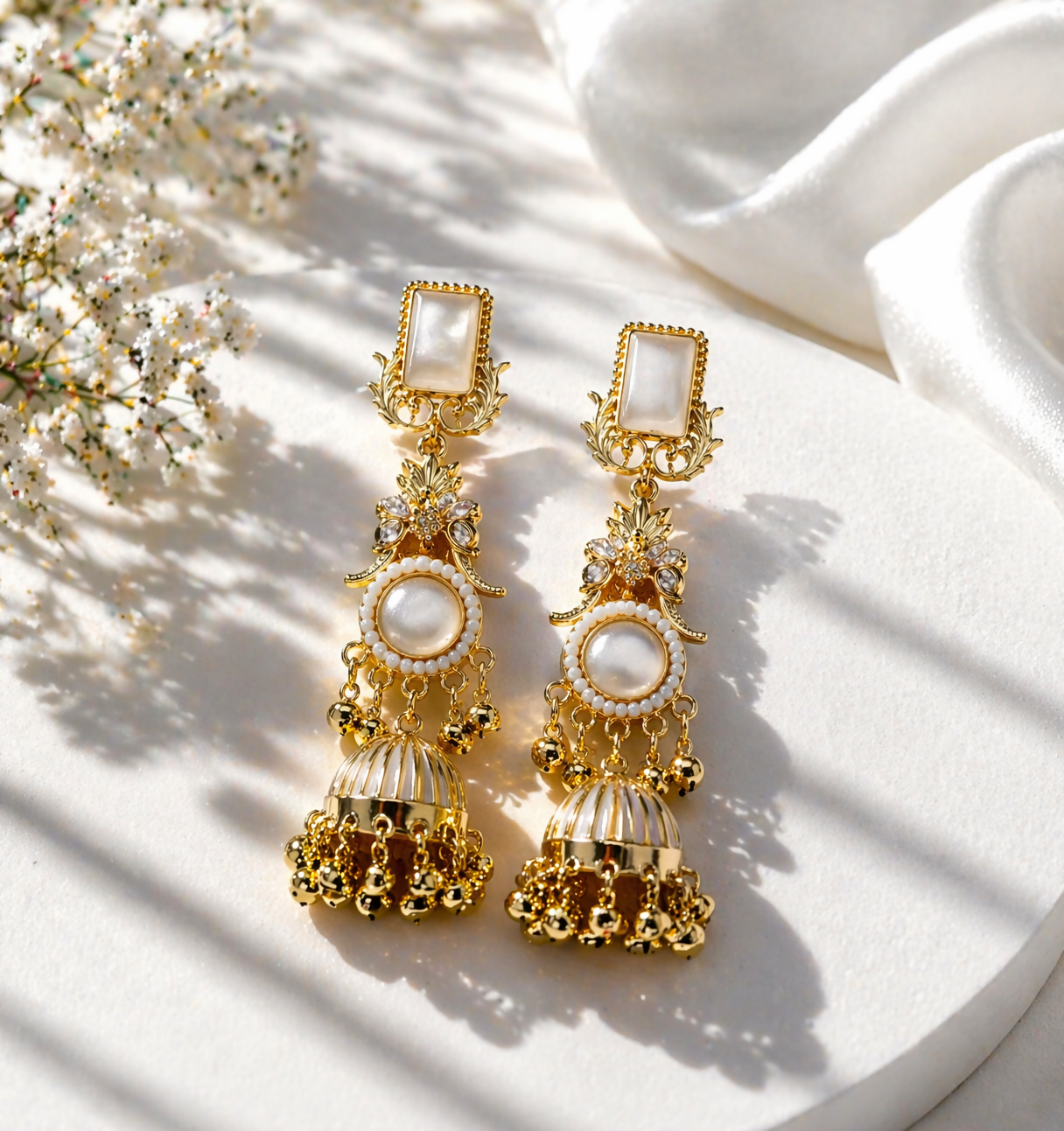 Close-up of premium gold-plated Kashmiri jhumka earrings showing intricate floral design