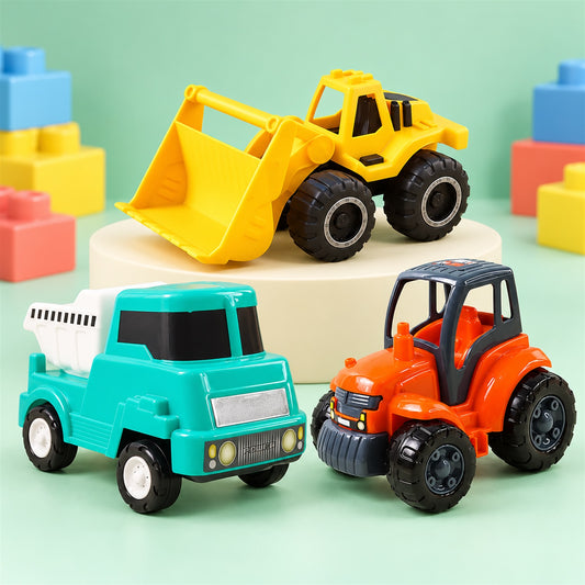 Three colorful plastic toy construction vehicles on a green background with building blocks.
