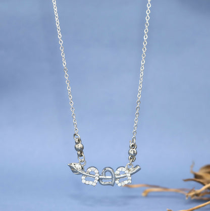 Close-up of silver tone double heart pendant pierced by Cupid's arrow with sparkling CZ stones