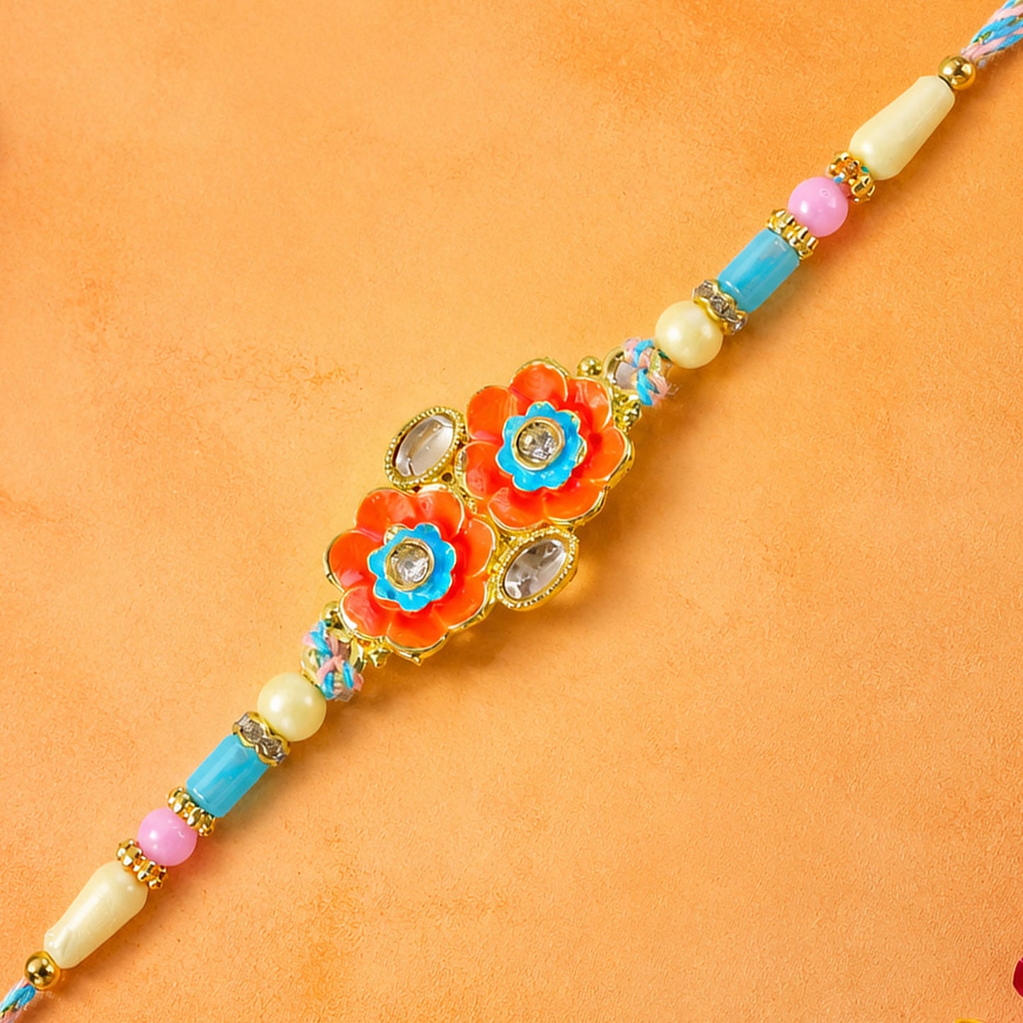 Ornate Rakhi with Butterfly Bloom Charm, multicolor stones and bead line for Gift Use