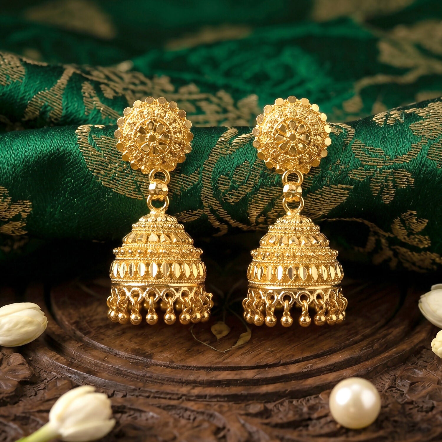 Elegant gold jhumka earrings worn with traditional attire