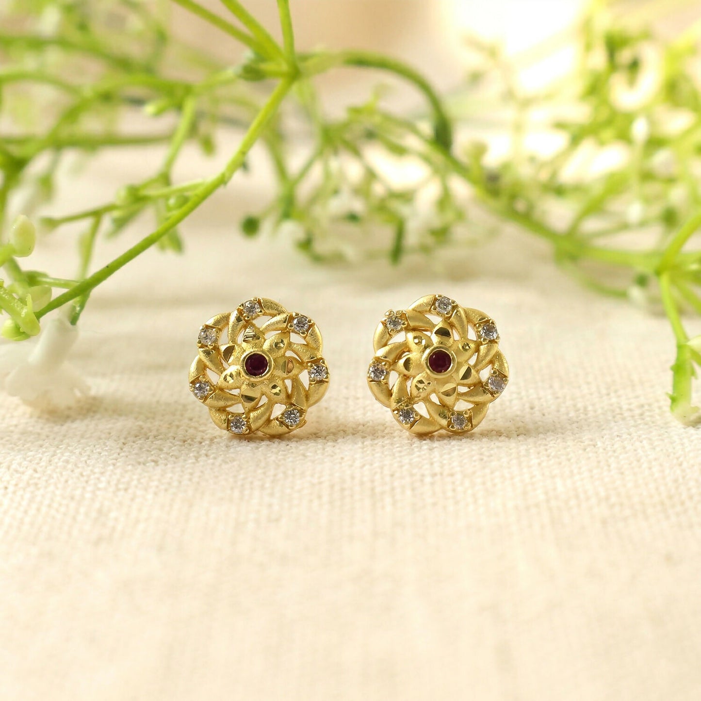 Fashionable gold earrings with geometric motifs and shimmering stones