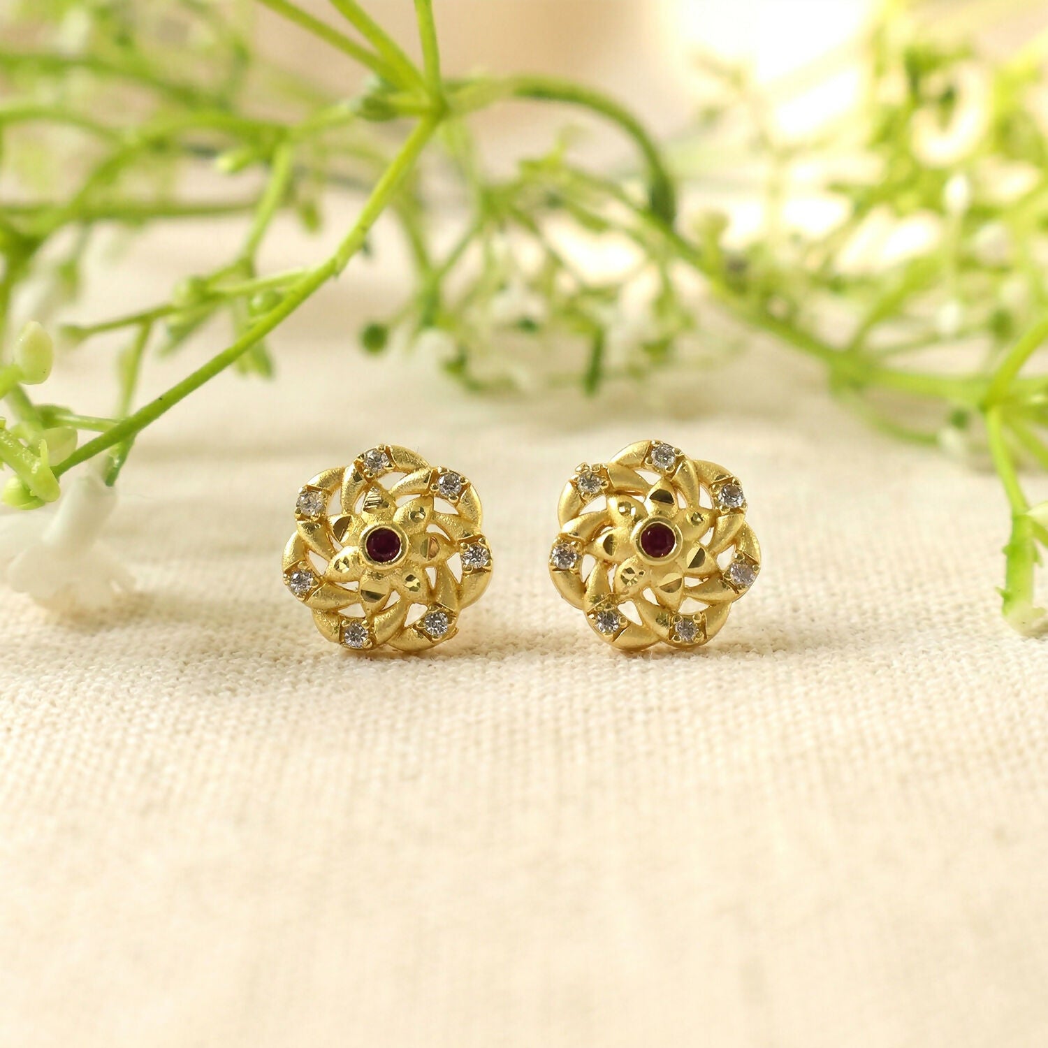 Fashionable gold earrings with geometric motifs and shimmering stones