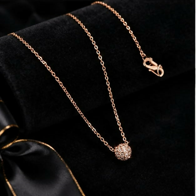 Close-up of gold-tone floral cluster pendant with sparkling clear stones