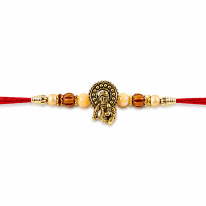 Antique Deity Idol Devotional Rakhi with Golden Medallion, Peach Beads and Red Thread