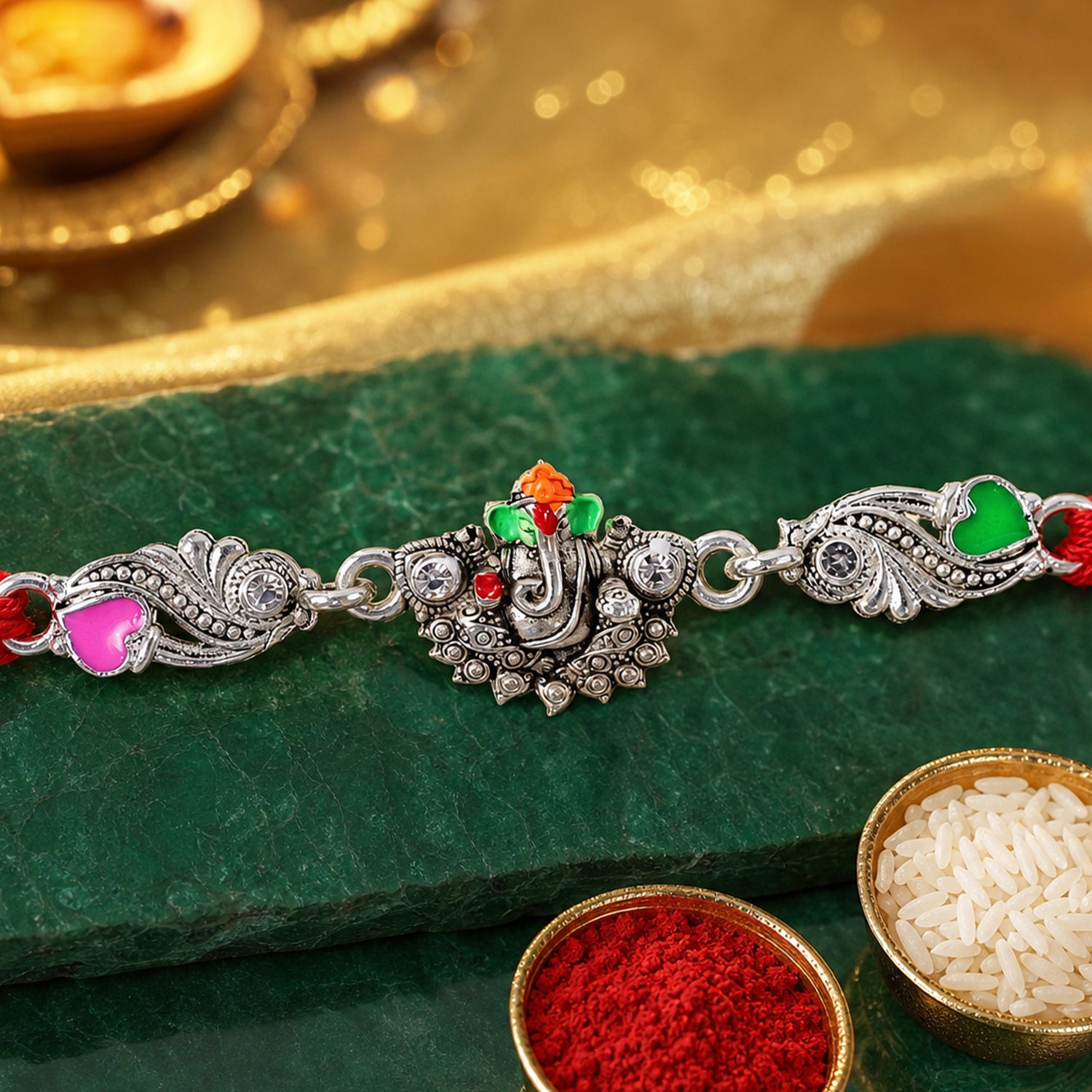 Silver-Toned Lord Ganesha Rakhi with Floral Design, Crystal Accents & Designer Red Thread