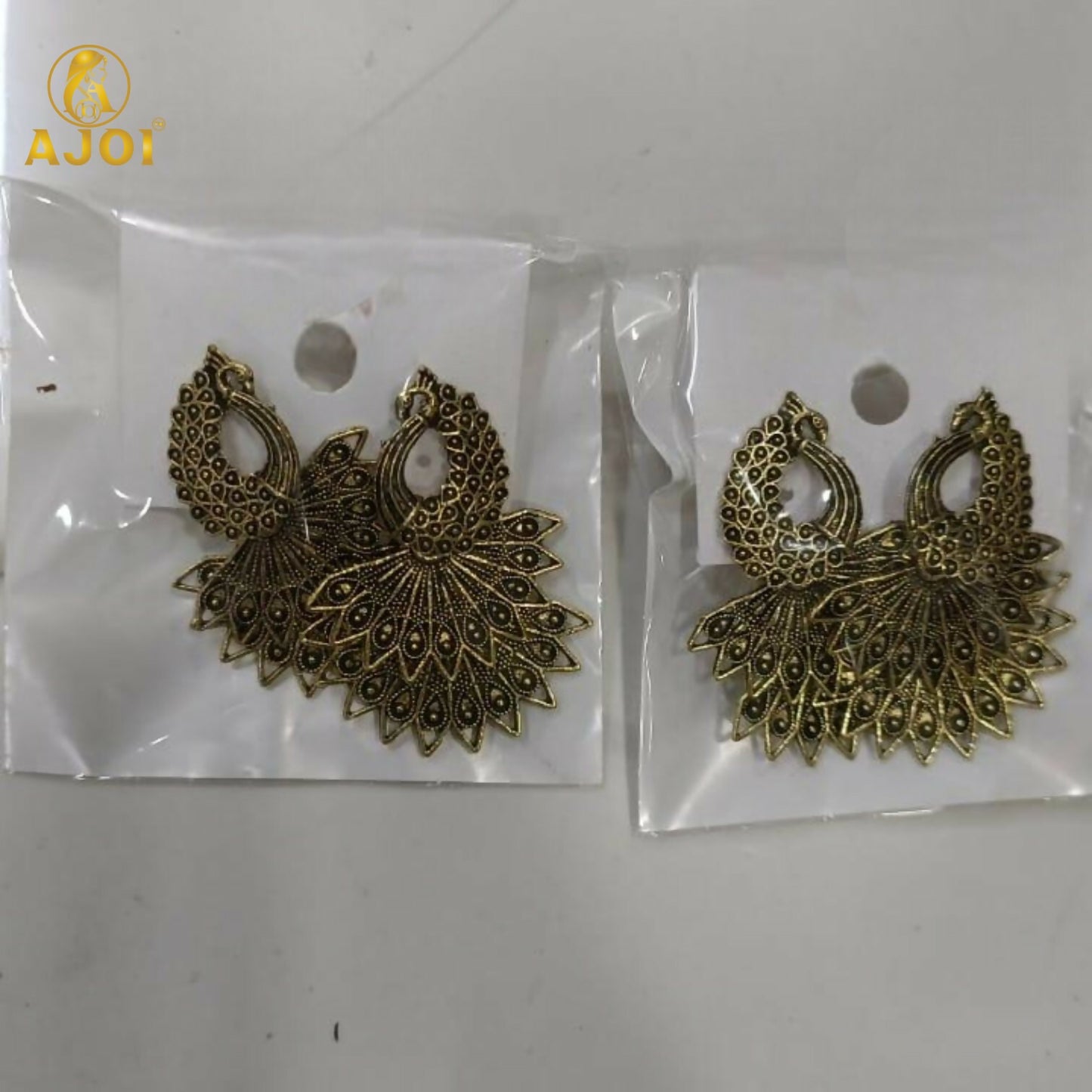 Detail of push-back closure on peacock earrings combo