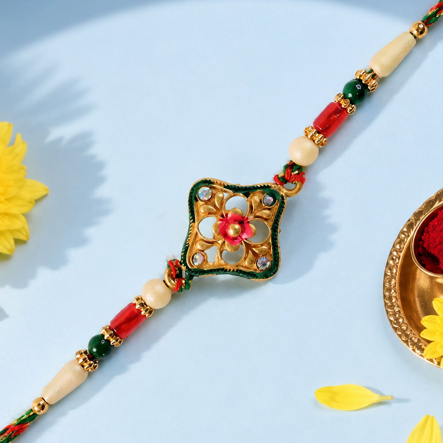 Green Enamel Kite Shaped Pendant Rakhi with Red Flower Center