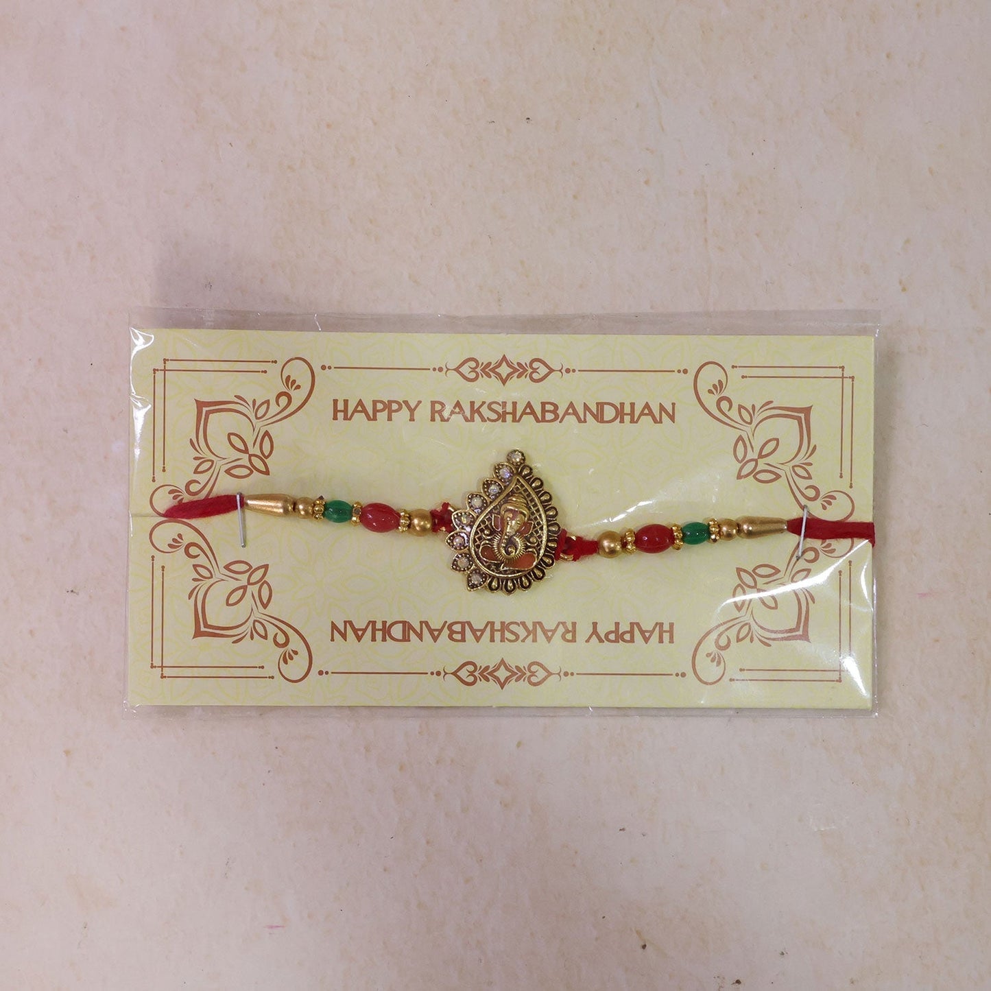 Antique Golden Ganesha Rakhi with Red & Green Beads and Crystals (10pcs)