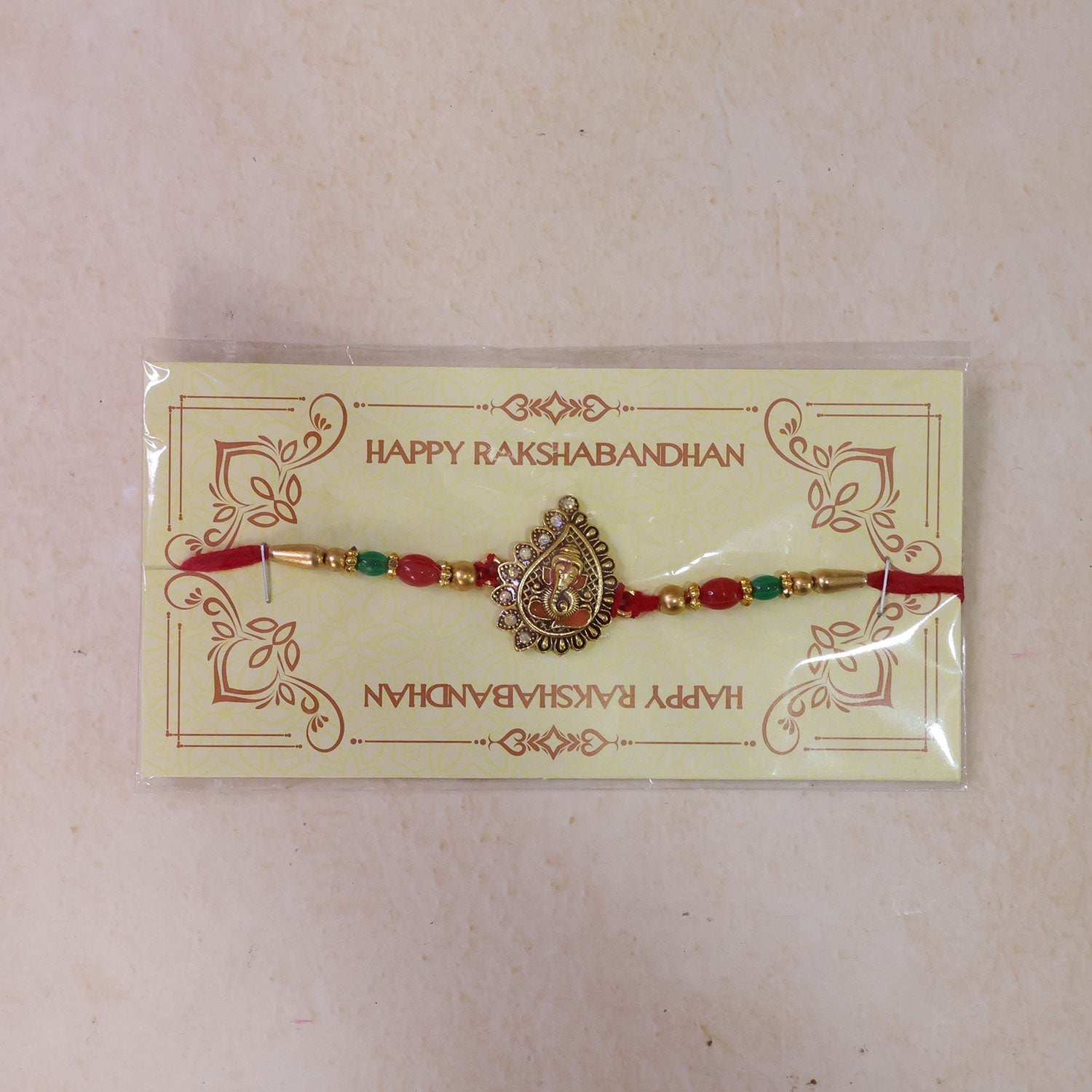 Antique Golden Ganesha Rakhi with Red & Green Beads and Crystals (5pcs)