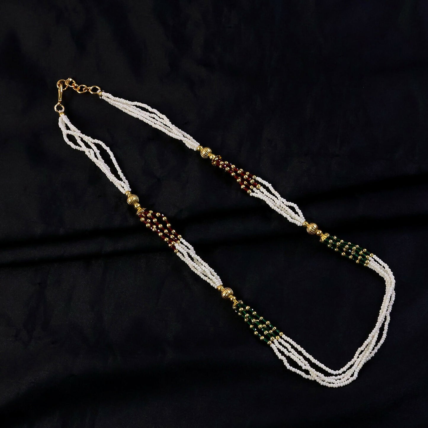 Handmade white mala necklace featuring detailed bead work and vibrant accents