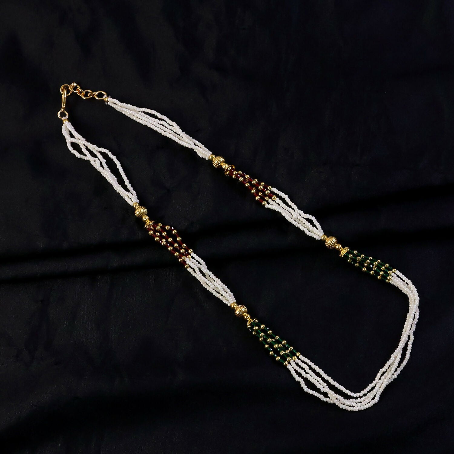 Handmade white mala necklace featuring detailed bead work and vibrant accents