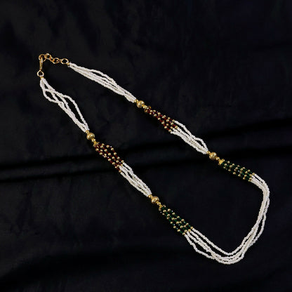 Handmade white mala necklace featuring detailed bead work and vibrant accents