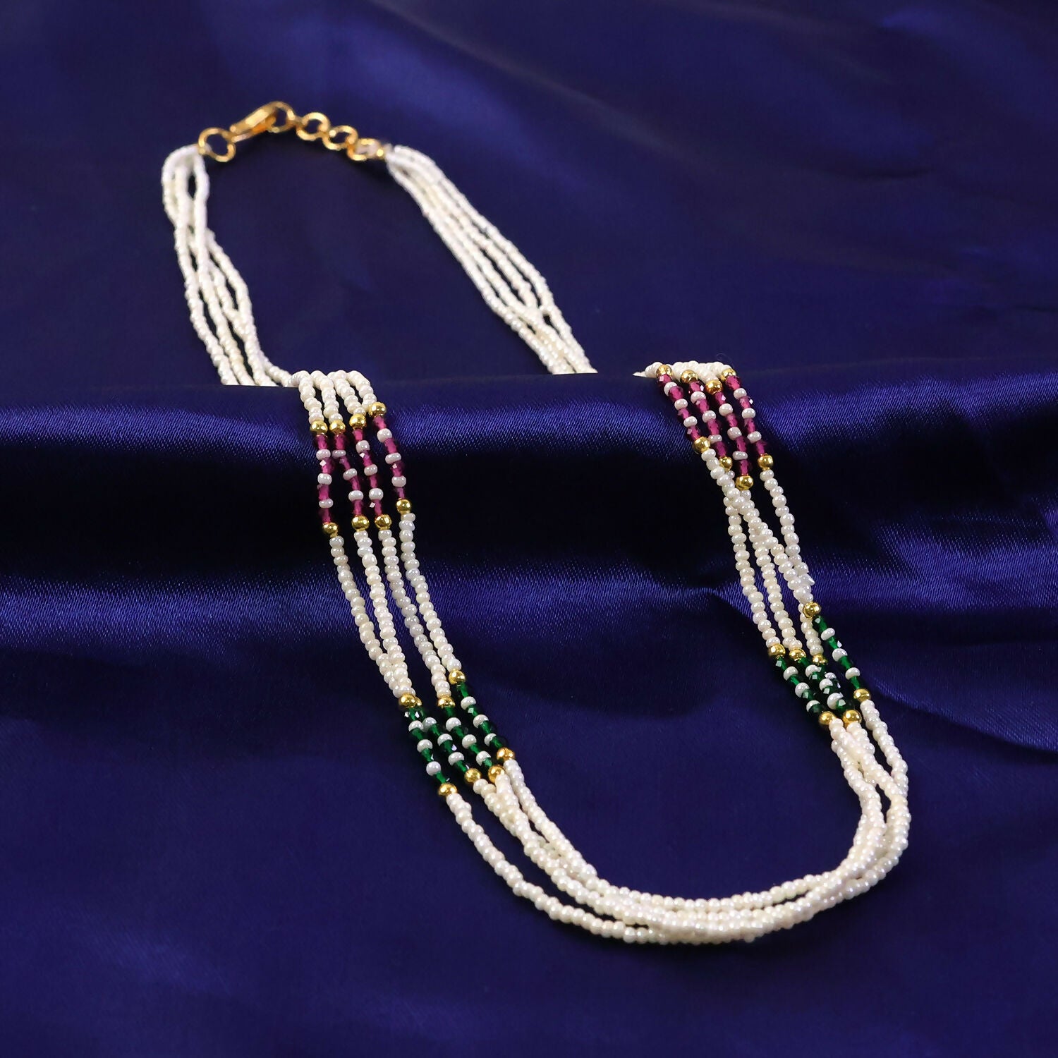 Close-up of pearl-like beads and vibrant colored beads on mala necklace