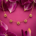 Ruby Blossom Floral Necklace – Elegant gold chain with red gemstone